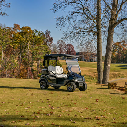 Club Car Tempo Golf cart in black with white premium seats on a golf course
