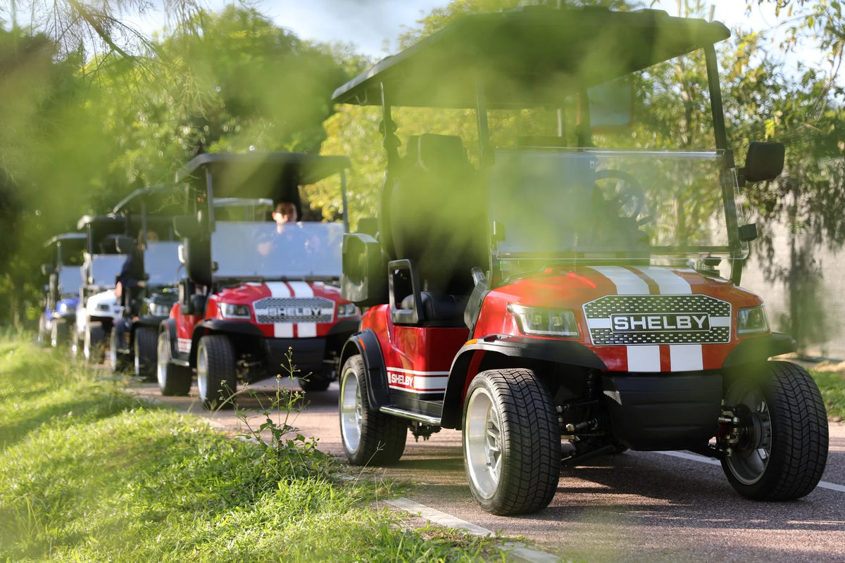 Shelby golf cars lined up on a path